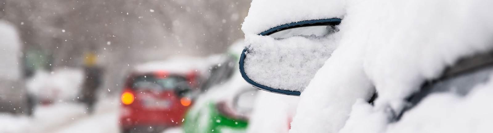 Close up of a car covered in snow